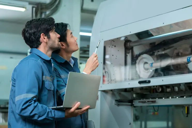 two workers with a manufacture software in the factory